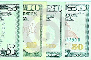 Top view shot of five, ten, twenty and fifty dollar banknotes