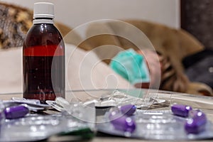 Top view of sick woman lying on a stretcher in a hospital attended by a person with bacteriological protective suit