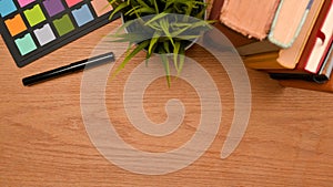 Top view of Simple workspace on wooden table with copy space for montage