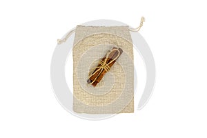Top view of single empty fabric cotton small bag (beige burlap pouch) isolated on white background.