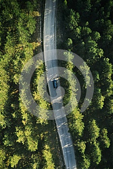 Top view of single gray car driving through forest in Zlatibor, Serbia