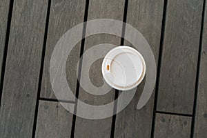 Top view of single hot latte on vintage wooden floor at relaxing