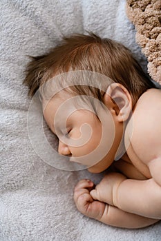 Top view of sleeping newborn in bed