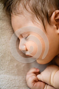 Top view of sleeping newborn in bed