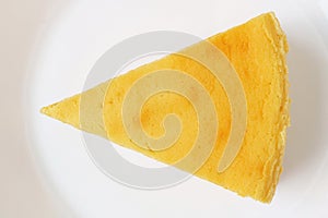 Top view of a slice of cheesecake on a white plate