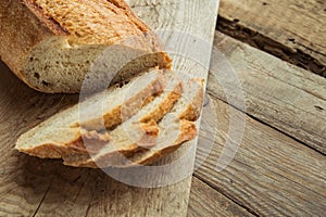 Top view of sliced wholegrain bread on a wooden table.