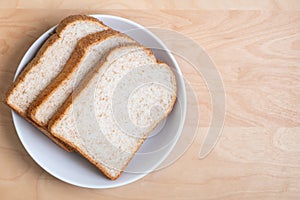 Top view of sliced wholegrain breads on wooden with space