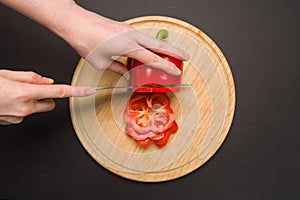 Top view of slicing red pepper on chopping board