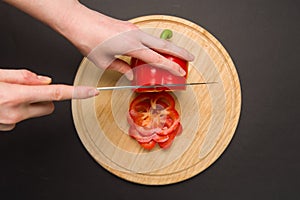 Top view of slicing red pepper on chopping board