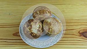 top view slowly zoom in at three large whole delicious baked muffins with coconut