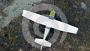 Top view of a small airplane turning around on the ground