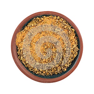 Top view of a small bowl filled with Cajun blackened seasoning isolated on a white background