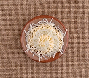 Sharp white cheddar cheese in a small bowl