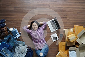 Top view small business owner woman lying on wooden floor
