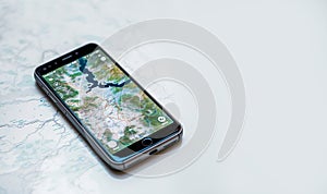 Top view of smartphone lying on a map use for Navigate or GPS. copy space. Empty space for text. technology,maps,mobile