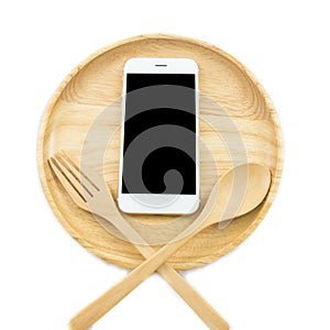 Top view smartphone on wooden dish with spon and fork on white background