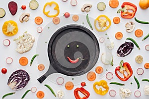 top view of smiley face from green peas and red pepper on round wooden board