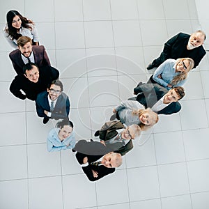 Top view. smiling business team looking at the camera.