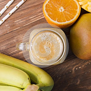 Top view smoothie jar with bananas and orange