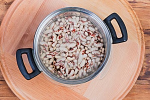 Top view of soaked speckled kidney beans in cooking pot
