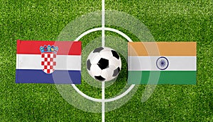 Top view soccer ball with Croatia vs. India flags match on green football field