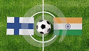 Top view soccer ball with Finland vs. India flags match on green football field