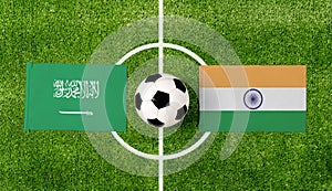 Top view soccer ball with Saudi Arabia vs. India flags match on green football field