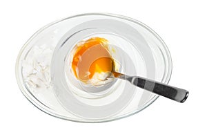 Top view of soft egg with spoon in glass egg cup