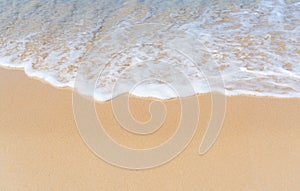 Top view of soft wave on sandy beach. Copy space