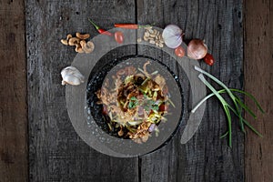 Top view of Somtam Papaya Salad with pork crackling