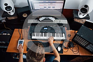 Top view. Sound engineer working and mixing music indoors in the studio