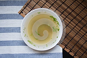 Top view of soup with wooden on background