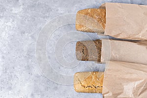 Top view of sourdough bread loaves, three different types: dark bread with seeds, white bread, whole grain bread