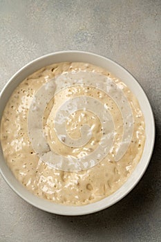 Top view sourdough starter in a bowl. Home baking, wild east, fermented food.