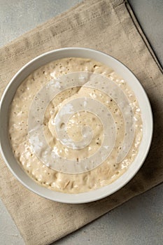 Top view sourdough starter in a bowl. Home baking, wild east, fermented food.