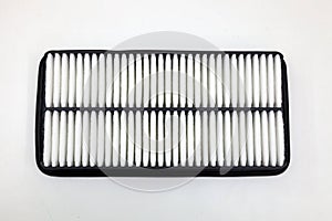 Top view on spare part for car engine air filter for cleaning dust and dirt on a white  background. Maintenance and oil