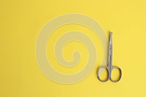 Top view of special nail scissors for babies on a yellow background