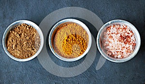 Top view, spices in bowl and ingredients for food, culinary and flavor with powder or ground seasoning for cooking