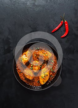 Top view of spicy and hot Bengali fish curry. Indian food. Fish curry with red chili, curry leaf, coconut milk. Asian cuisine.