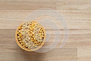 Top view of split soybeans in a bowl on wooder background, Healthy eating concept