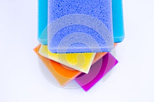 Top view of sponges for washing dishes, on a white background, isolated. Colorful multi-colored as rainbow sponges lay one each