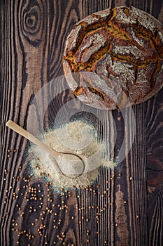 Top view spoon with buckwheat flour and bread