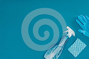 top view of spray bottle and rubber glove with washing sponge