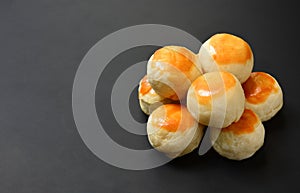 Top view stack of Chinese pastry or Chinese spring rolls on black color background with copy space