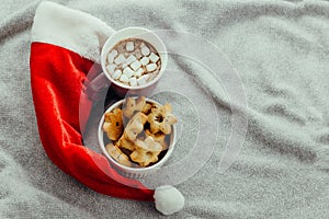 starshaped cookies,hot chocolate and Santa Claus red hat photo