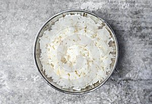 Top view steamed rice in a stainless bowl on the gray concrete table