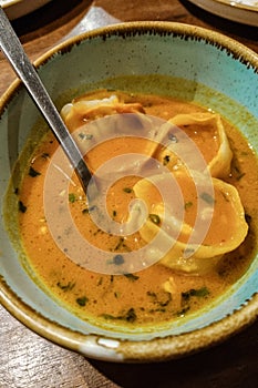 Top view of steamed soup of momo served in a ceramic bowl. A popular Nepalese food that is also common in China, Bhutan, Tibet and