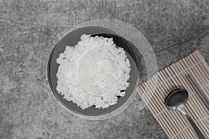 Top view steamed white rice on black bowl