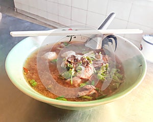 Top view, stewed beef noodles, Chinese herbs with vegetables in hot soup, Asian food concept