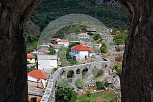 Top view through a stone arch with a fortress. Aqueduct in the Old Bar in Montenegro.